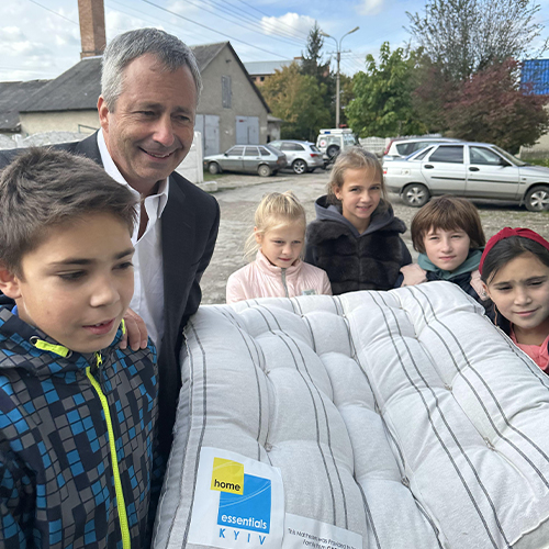 Ukranian kids hold a mattress